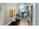 Spacious hallway with a unique light fixture and tile flooring sets the tone for the rest of this beautiful home at 13201 Wellington Hills Dr, Riverview, FL 33579