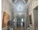 Inviting hallway with decorative lighting, tile floors and stylish decor provides a warm welcome to this well-appointed home at 13201 Wellington Hills Dr, Riverview, FL 33579