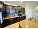 Close-up showcases the kitchen's dark cabinetry, stainless steel appliances, granite countertops, and stylish backsplash at 13201 Wellington Hills Dr, Riverview, FL 33579