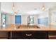 Spacious kitchen island with sink and granite countertops, perfect for food preparation at 13201 Wellington Hills Dr, Riverview, FL 33579