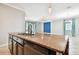 Open-concept kitchen overlooking the dining area, featuring a granite countertop island with a sink at 13201 Wellington Hills Dr, Riverview, FL 33579