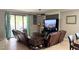 Bright living room with neutral walls, tile floors, and sliding glass doors to the patio at 13201 Wellington Hills Dr, Riverview, FL 33579