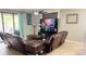 Comfortable living room showcasing neutral walls, tile floors, and access to outdoor patio at 13201 Wellington Hills Dr, Riverview, FL 33579