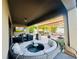 Covered patio featuring a modern lounge area, grill, TV, and adjacent pergola-covered dining area for entertaining at 13201 Wellington Hills Dr, Riverview, FL 33579