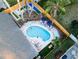 Aerial view showcasing the pool, outdoor entertainment areas, and well-maintained backyard landscaping at 1394 Stonehenge Way, Palm Harbor, FL 34683
