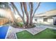 Backyard oasis with mini golf, putting green and mature landscaping creating a serene retreat at 1394 Stonehenge Way, Palm Harbor, FL 34683