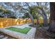 Backyard with lush landscaping, putting green, bowling, shaded by beautiful mature trees at 1394 Stonehenge Way, Palm Harbor, FL 34683