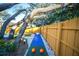 Private backyard with putting green, bowling and mature trees creating a serene oasis for outdoor fun at 1394 Stonehenge Way, Palm Harbor, FL 34683