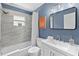Relax in the stylish bathroom featuring a shower-tub combo and a modern vanity at 1394 Stonehenge Way, Palm Harbor, FL 34683