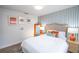 Bright bedroom with a full bed, art, and orange lamps provides a cozy feel at 1394 Stonehenge Way, Palm Harbor, FL 34683