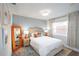 Bright bedroom with a full bed, art, and a unique orange mirror provides a cozy feel at 1394 Stonehenge Way, Palm Harbor, FL 34683