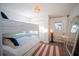 Cozy bedroom features a bunk bed, a chair with a floor mirror, and a ceiling fan at 1394 Stonehenge Way, Palm Harbor, FL 34683