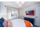 This bedroom offers a TV and a light-filled window view to the exterior at 1394 Stonehenge Way, Palm Harbor, FL 34683