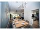 Open dining area with a large table, stylish lighting, and seamless connection to the living room and kitchen at 1394 Stonehenge Way, Palm Harbor, FL 34683