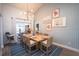 Bright dining room featuring a table set for eight, a stylish light fixture, and sliding glass doors at 1394 Stonehenge Way, Palm Harbor, FL 34683