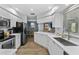 Bright kitchen with stainless steel appliances, white countertops, wood floors, and backyard views at 1394 Stonehenge Way, Palm Harbor, FL 34683