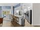 Modern kitchen with stainless steel appliances, white cabinets, and breakfast bar with seating at 1394 Stonehenge Way, Palm Harbor, FL 34683