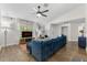 Modern living room with comfortable seating, a large TV, and stylish decor, perfect for relaxation and entertainment at 1394 Stonehenge Way, Palm Harbor, FL 34683