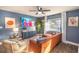 Comfortable living room featuring a blue accent wall, stylish furnishings, and natural light from the window at 1394 Stonehenge Way, Palm Harbor, FL 34683