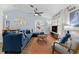 Inviting living room featuring blue walls, comfortable seating, and stylish decor for relaxation and entertainment at 1394 Stonehenge Way, Palm Harbor, FL 34683