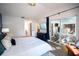 This main bedroom offers a TV, access to a patio, streamlined furnishings, and natural light at 1394 Stonehenge Way, Palm Harbor, FL 34683