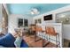 Comfortable screened porch with bar, table, and ceiling fan for enjoying the outdoors at 1394 Stonehenge Way, Palm Harbor, FL 34683
