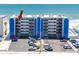 Aerial view of beachfront condo building with parking lot and ocean access at 14300 Gulf Blvd # 401, Madeira Beach, FL 33708