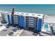 Aerial view of beachfront condo building with parking lot and pool at 14300 Gulf Blvd # 401, Madeira Beach, FL 33708