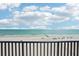 Balcony overlooking a white sandy beach and tranquil blue ocean view at 14300 Gulf Blvd # 401, Madeira Beach, FL 33708