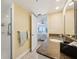 Well-lit bathroom featuring a walk-in shower and sink with a granite countertop at 14300 Gulf Blvd # 401, Madeira Beach, FL 33708
