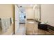 Bathroom features granite countertops and a view into the primary bedroom at 14300 Gulf Blvd # 401, Madeira Beach, FL 33708