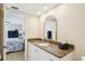 Well-lit bathroom with granite countertops, decorative mirror, and a stylish vanity at 14300 Gulf Blvd # 401, Madeira Beach, FL 33708