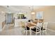 Bright dining room with seating for six and a passthrough to the kitchen area at 14300 Gulf Blvd # 401, Madeira Beach, FL 33708