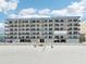 Beachfront condo building view with beach access, balconies, and coastal charm at 14300 Gulf Blvd # 401, Madeira Beach, FL 33708
