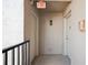 Neutral hallway with textured walls and an 'Exit' sign, revealing two doors and railing at 14300 Gulf Blvd # 401, Madeira Beach, FL 33708