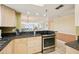 Open-concept kitchen featuring stainless appliances and views of the living area at 14300 Gulf Blvd # 401, Madeira Beach, FL 33708
