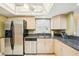 Well-lit kitchen with stainless steel appliances and ample countertop space at 14300 Gulf Blvd # 401, Madeira Beach, FL 33708