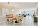 Bright open-concept living area with tile flooring, comfortable furnishings, and ocean views at 14300 Gulf Blvd # 401, Madeira Beach, FL 33708