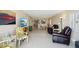 Spacious living area with tile floors, comfortable furnishings, and ocean views from the balcony at 14300 Gulf Blvd # 401, Madeira Beach, FL 33708