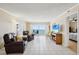 Bright living room with balcony access, comfortable leather seating, and calming ocean view at 14300 Gulf Blvd # 401, Madeira Beach, FL 33708