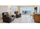 Cozy living room with tile floors, leather seating, and a balcony overlooking the ocean at 14300 Gulf Blvd # 401, Madeira Beach, FL 33708