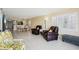 Open-concept living and dining area with tile floors, modern lighting, and comfortable furnishings at 14300 Gulf Blvd # 401, Madeira Beach, FL 33708
