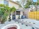 Inviting backyard featuring a cozy fire pit and a beautifully landscaped area with decorative rocks at 14611 Pine Glen Cir, Lutz, FL 33559