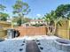 White rock backyard with a wooden fence and a fire pit at 14611 Pine Glen Cir, Lutz, FL 33559