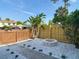 Relaxing backyard featuring a fire pit, rock landscaping, and a lush tropical plant at 14611 Pine Glen Cir, Lutz, FL 33559