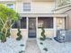 Charming screened-in porch with spiral topiaries, leading to a decorative rock garden and a peaceful outdoor retreat at 14611 Pine Glen Cir, Lutz, FL 33559