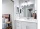Bathroom with white vanity and neutral walls next to a cozy bedroom at 14611 Pine Glen Cir, Lutz, FL 33559