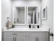 Modern bathroom features white cabinetry, dual mirrors, and a quartz countertop at 14611 Pine Glen Cir, Lutz, FL 33559