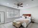 Bedroom with wood-look floors, a ceiling fan, window and neutral decor at 14611 Pine Glen Cir, Lutz, FL 33559