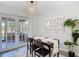 Dining room boasting new floors, stylish lighting, and access to the outdoor patio at 14611 Pine Glen Cir, Lutz, FL 33559